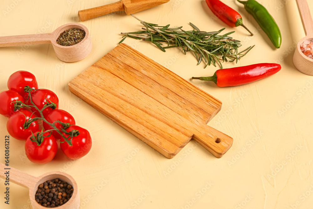 Composition with wooden cutting board, spices and vegetables on color background