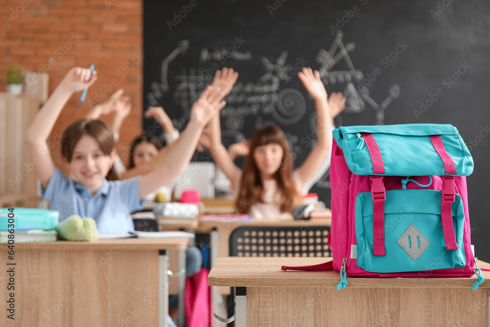 Backpack on desk in classroom, closeup