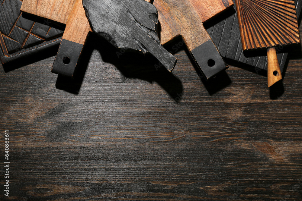 Different cutting boards on wooden background