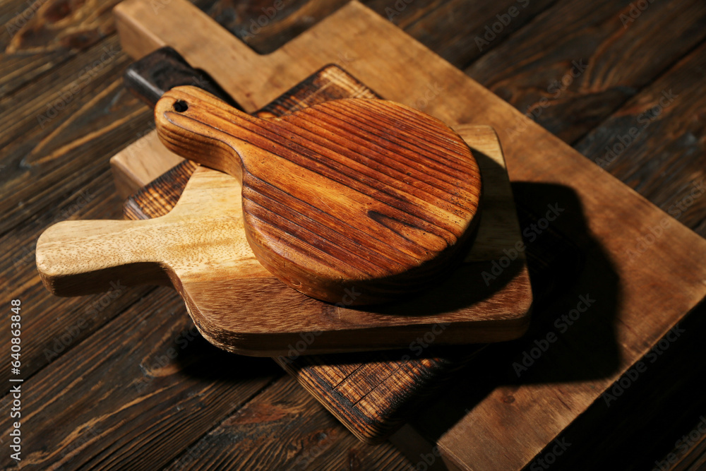 Different cutting boards on wooden background