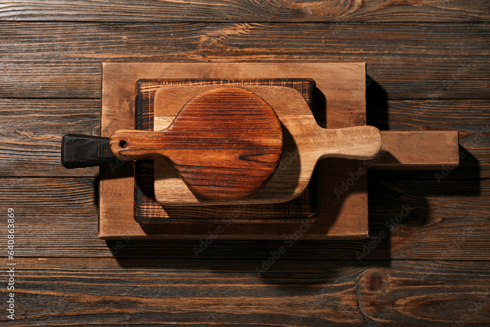 Different cutting boards on wooden background