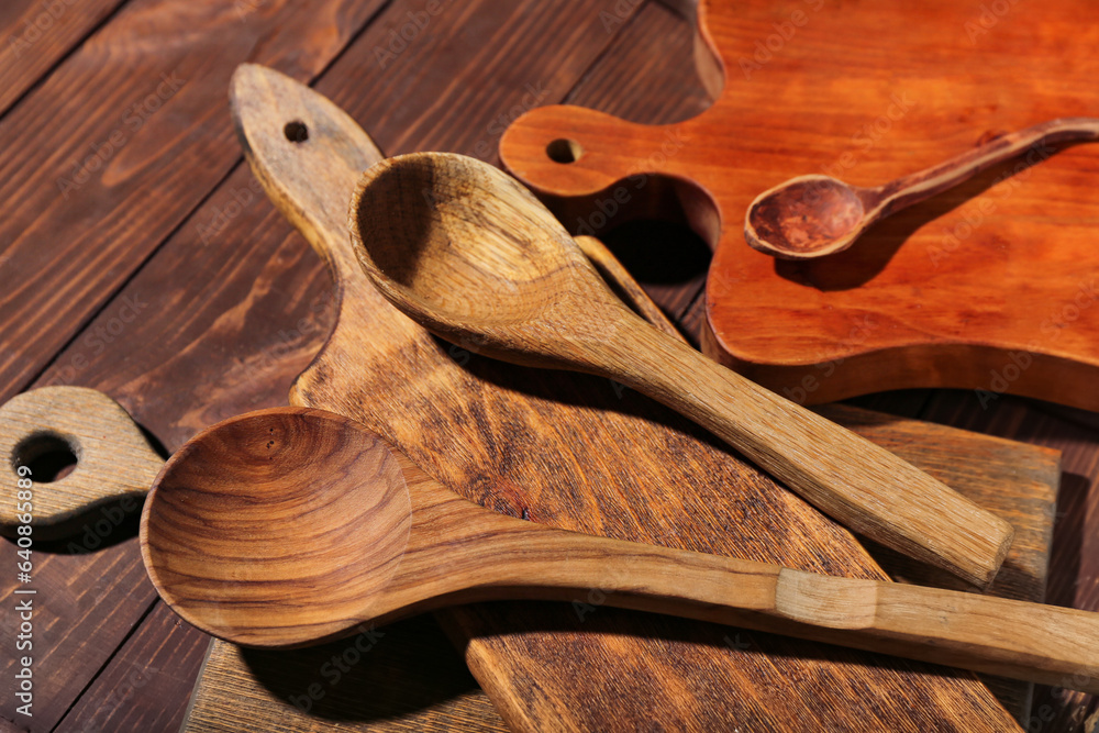 Different cutting boards and spoons on wooden background