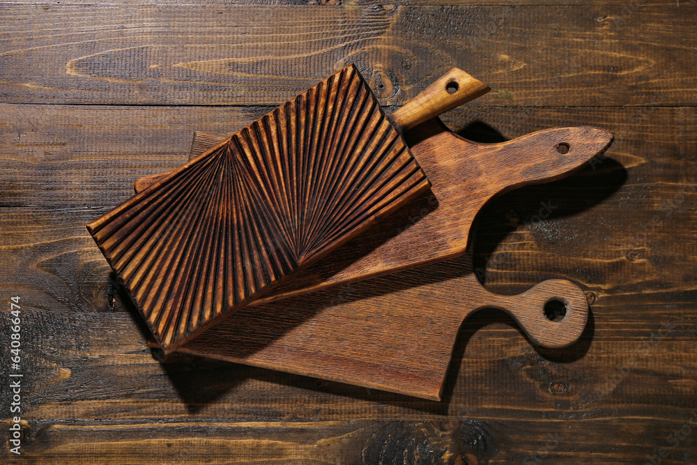 Different cutting boards on wooden background