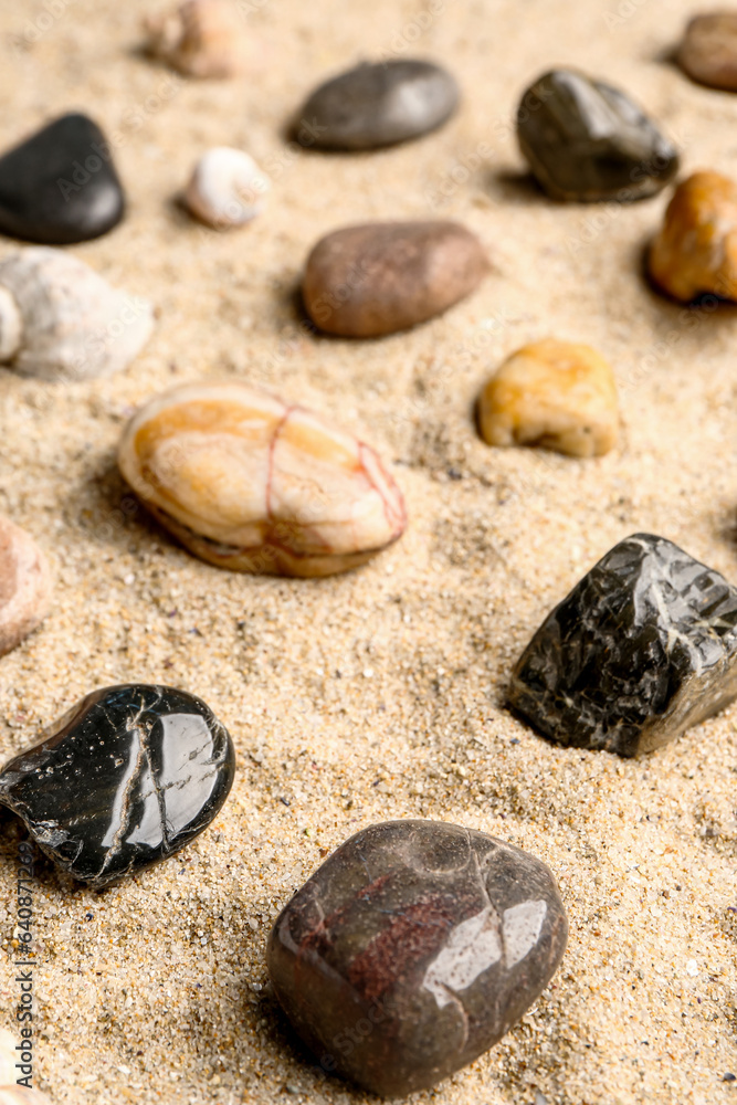 Many pebble stones on sand