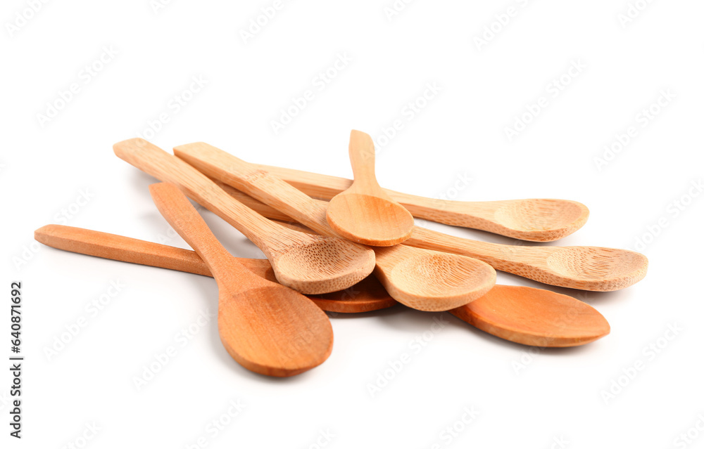 Heap of wooden spoons isolated on white background