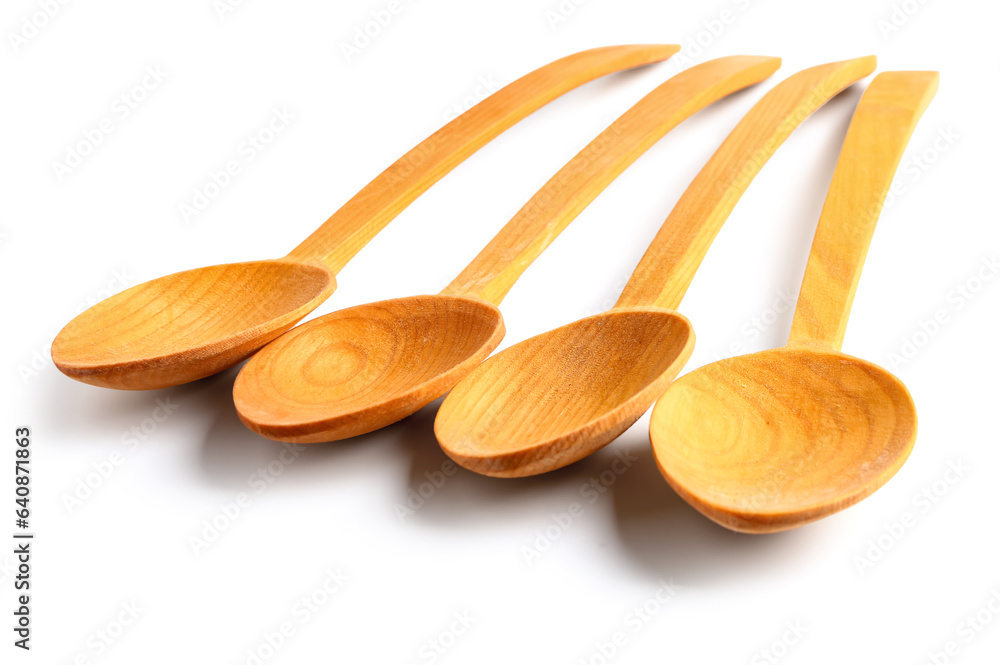 Empty wooden spoons isolated on white background