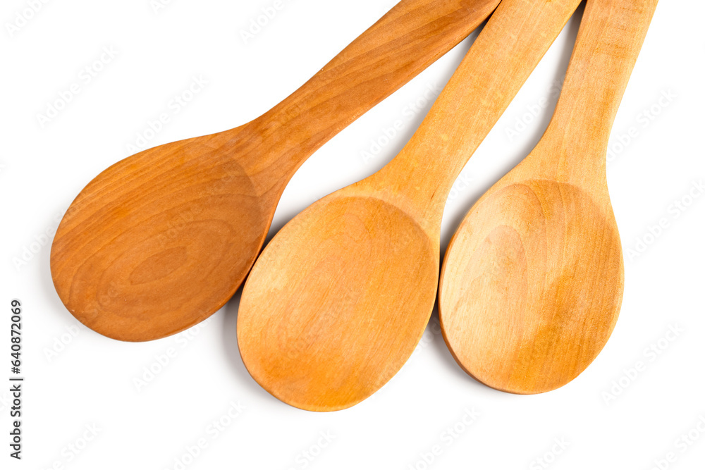 Empty wooden spoons isolated on white background, closeup