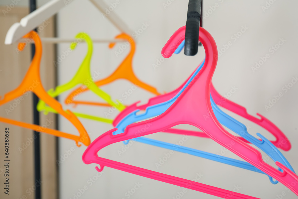 Plastic clothes hangers on grey background