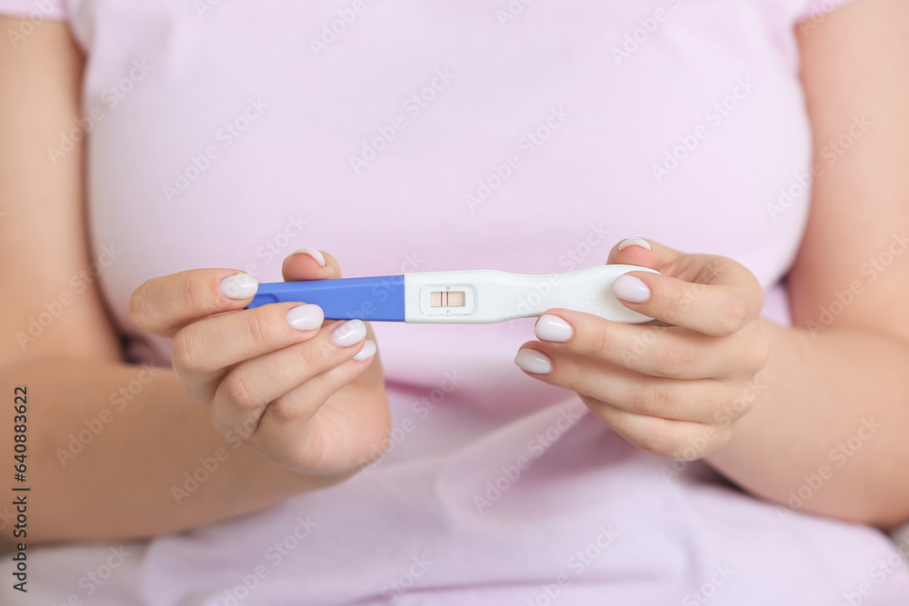 Young woman with positive pregnancy test, closeup