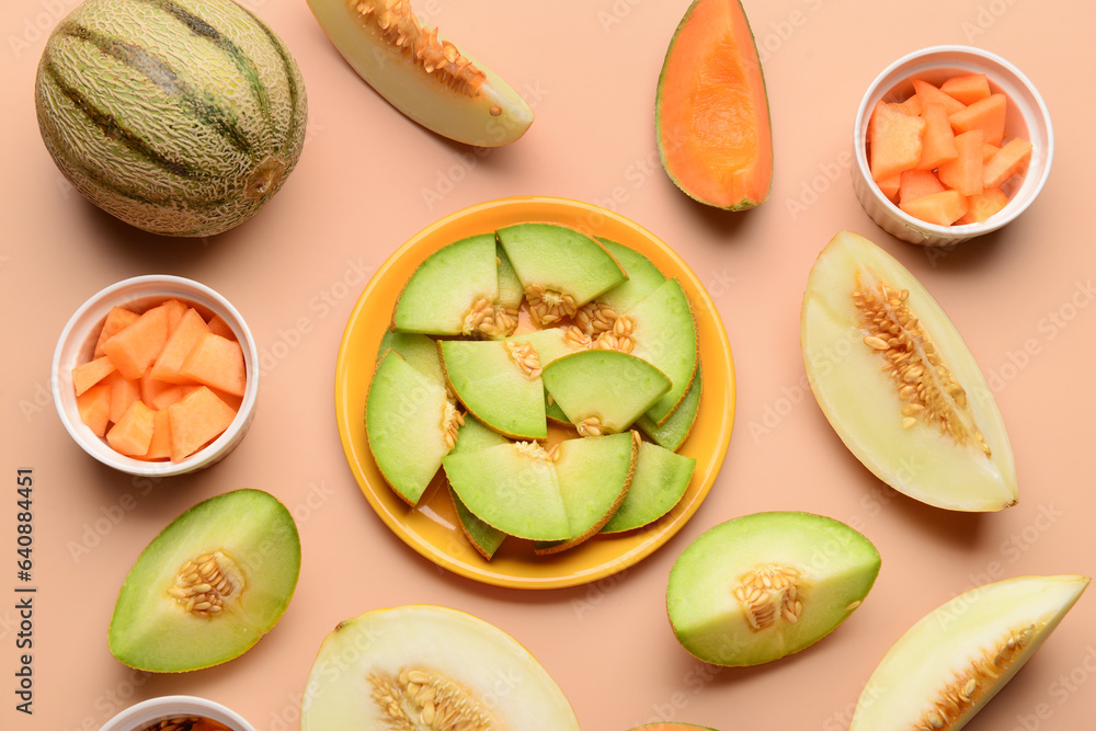 Plate and bowls with pieces of sweet melon on orange background