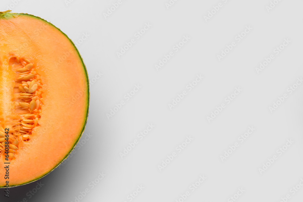 Half of sweet melon on grey background