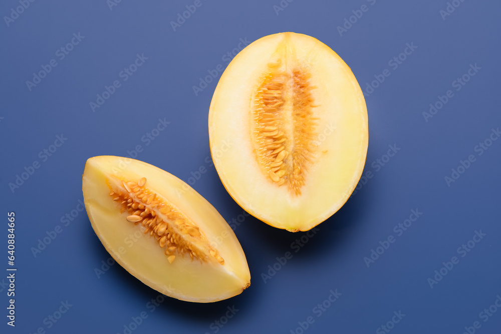 Pieces of sweet melon on blue background