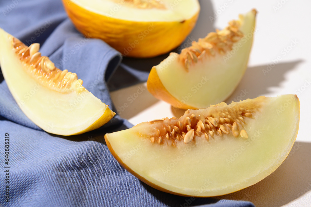 Pieces of sweet melon on white background