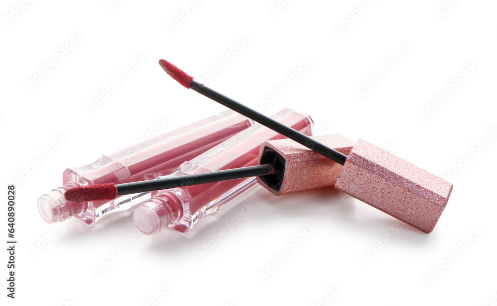 Beautiful liquid pink lipsticks on white background