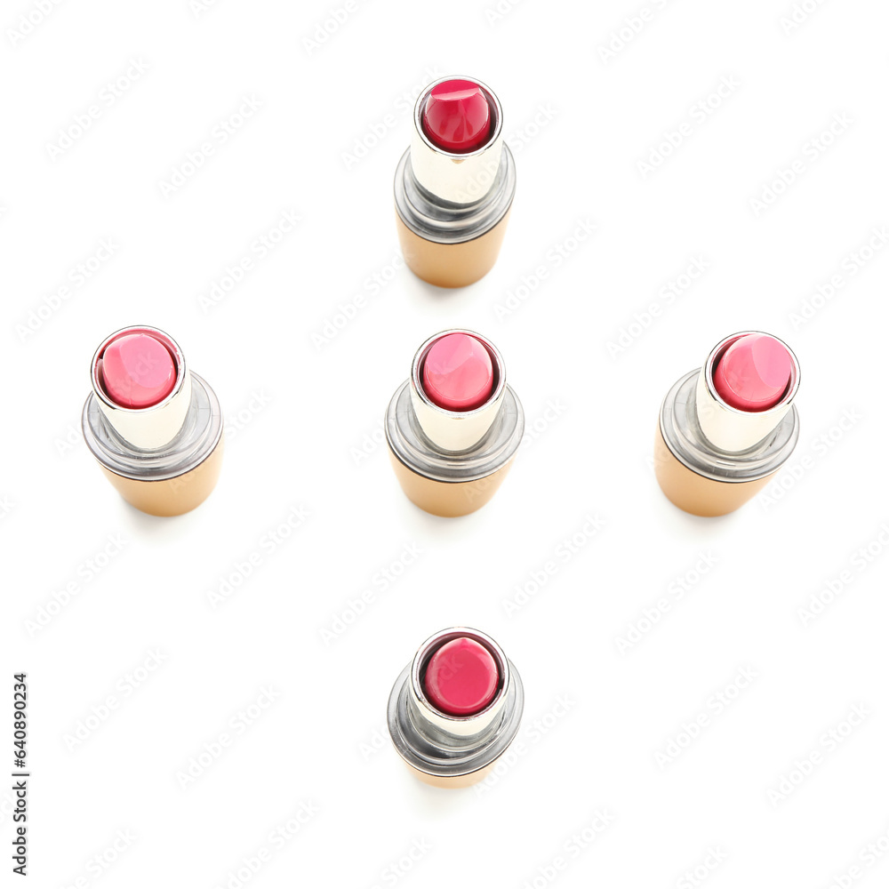 Different lipsticks on white background