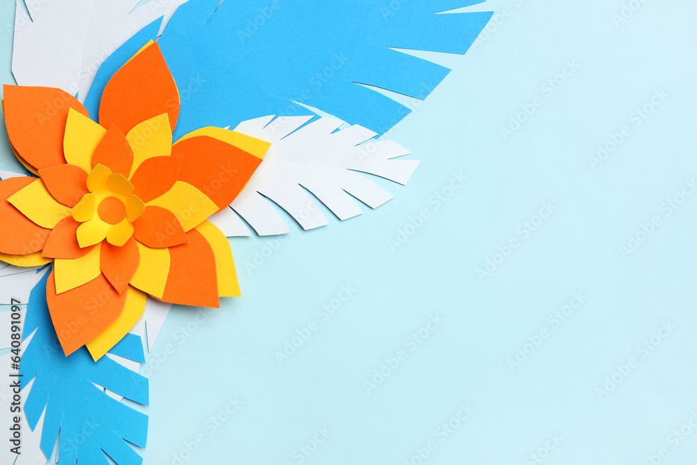 Colorful origami flower with leaves on light blue background