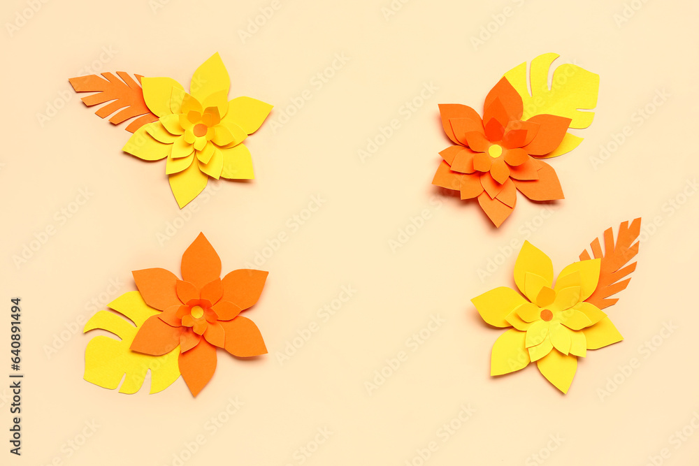 Colorful origami flowers with leaves on beige background