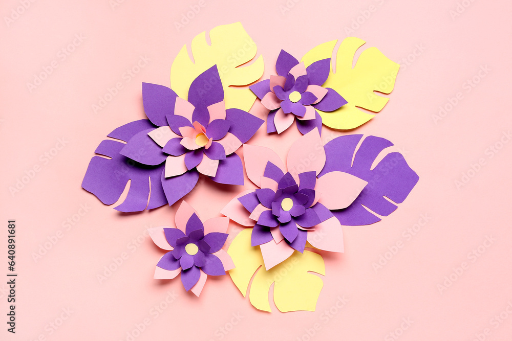 Colorful origami flowers with leaves on pink background