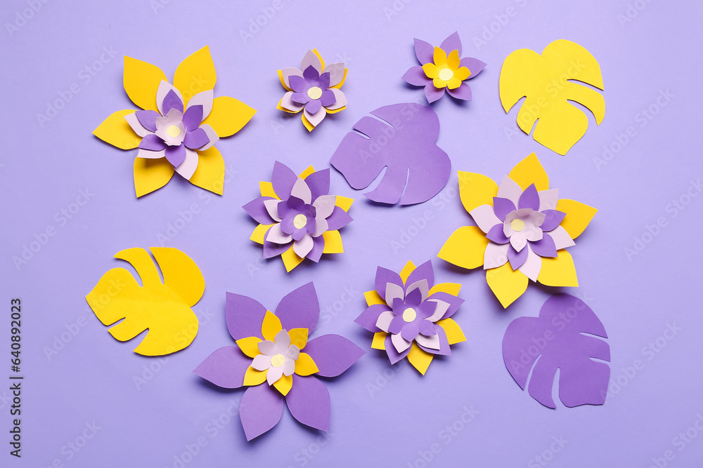 Colorful origami flowers and leaves on purple background