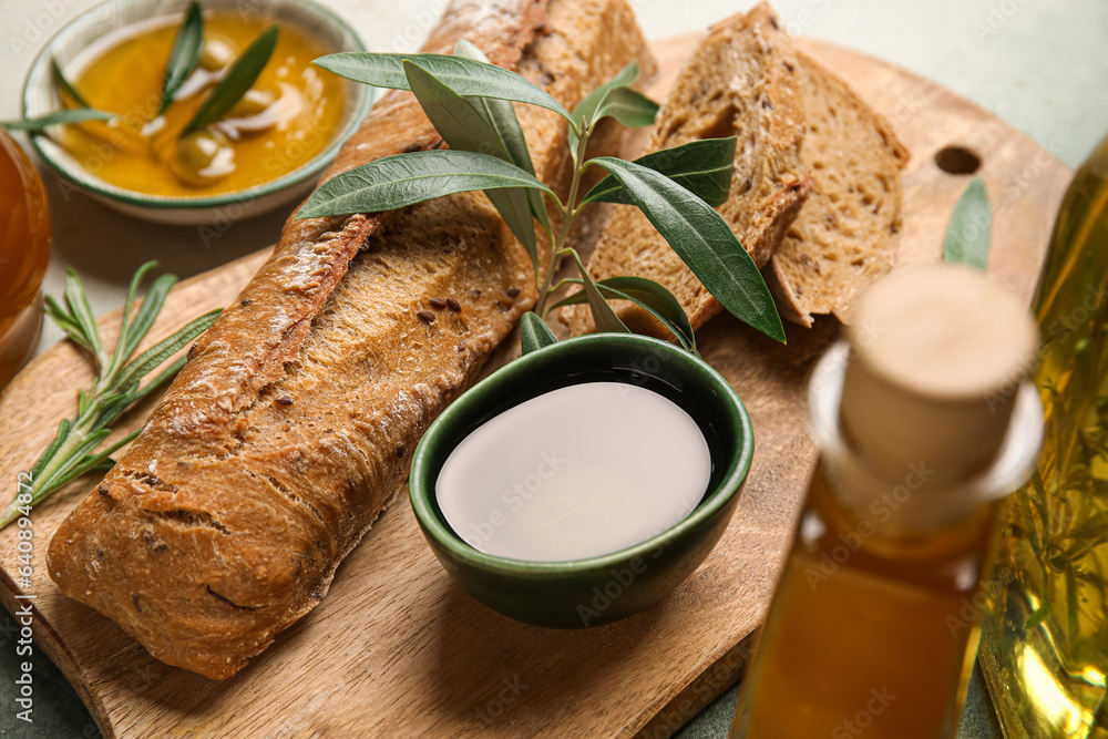 Bowl of fresh olive oil and bread on table