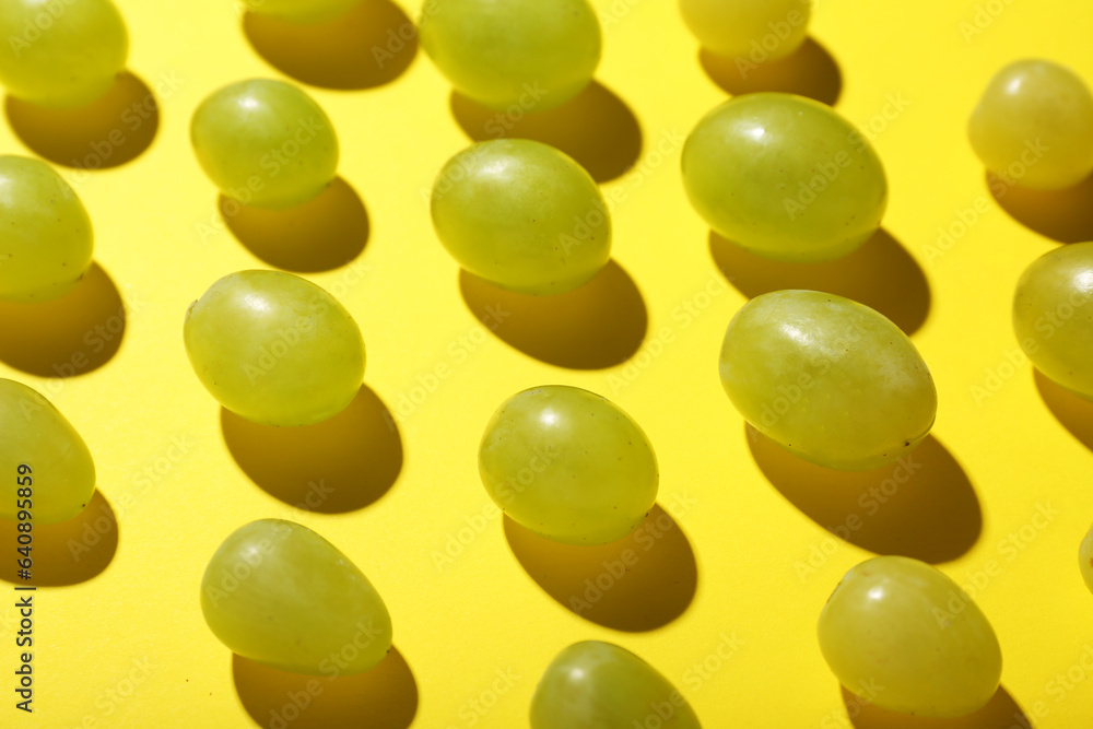 Sweet green grapes on yellow background