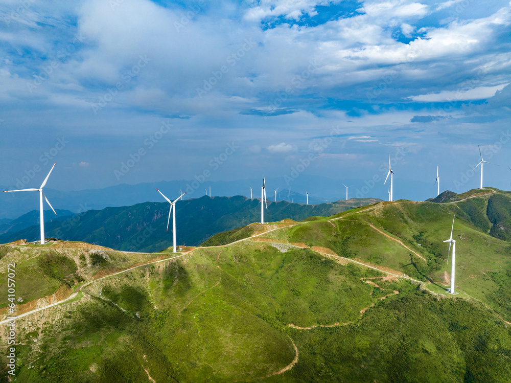 Wind power on the mountain, blue sky and white clouds