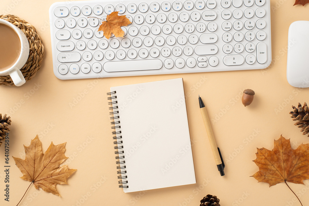 Warm autumn office scene. Top view featuring keyboard, mouse, cup of cocoa, spiral notebook, pen, pi