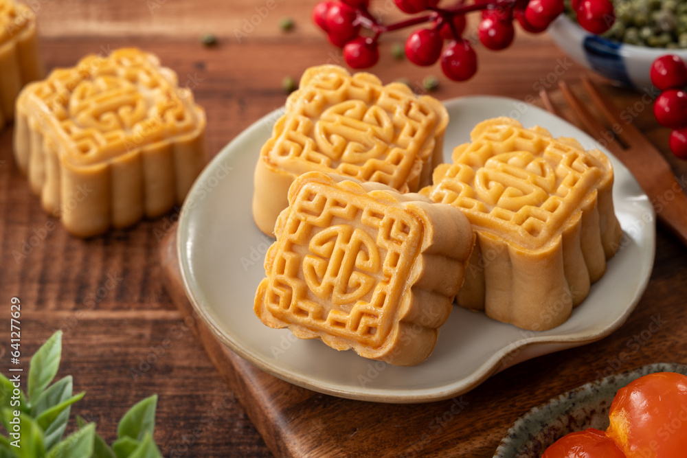 Delicious Cantonese moon cake for Mid-Autumn Festival food mooncake on wooden table background.