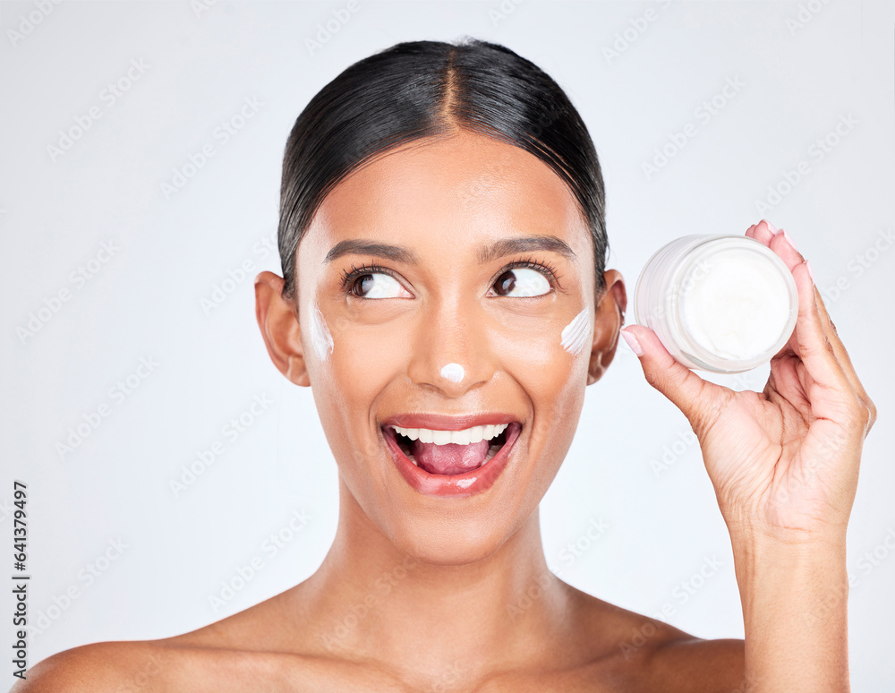 Woman, happy surprise with cream on face and beauty, moisturizer and skincare with container on whit