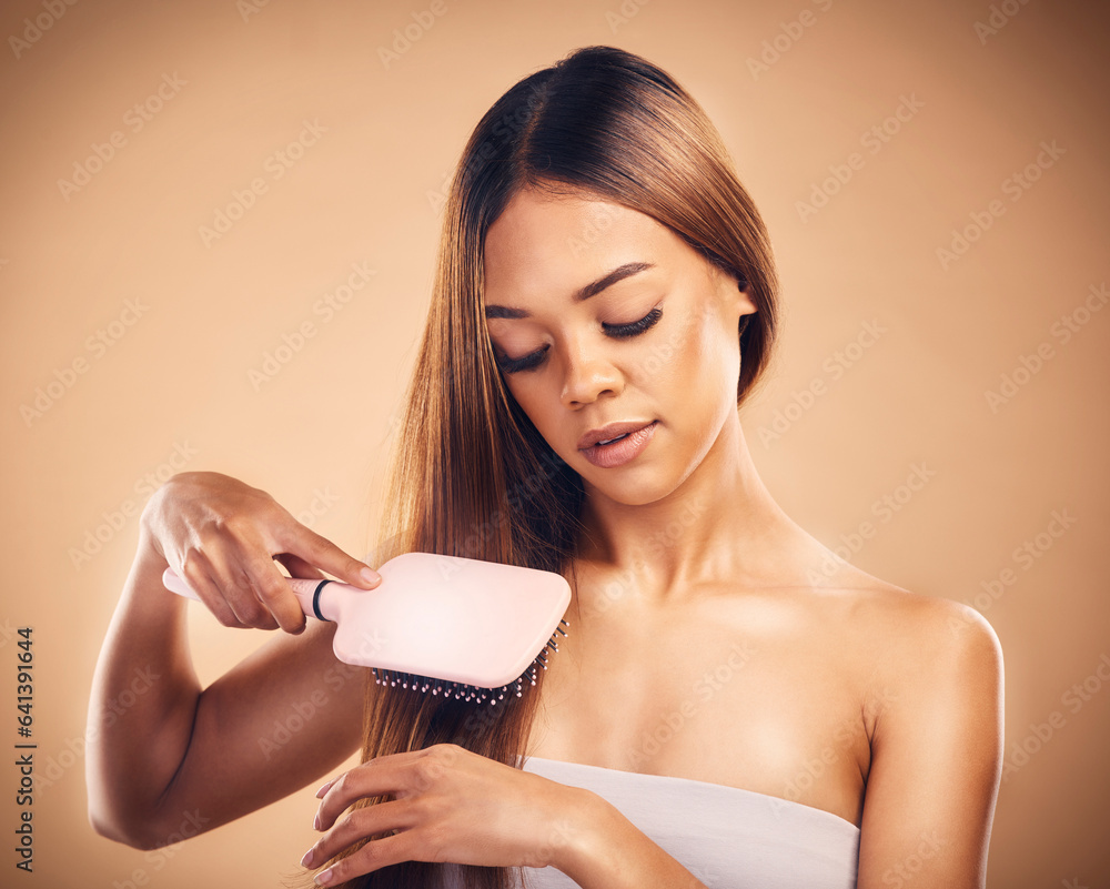 Hair, brush and a woman in studio for beauty, cosmetics and shine. Aesthetic model person on brown b