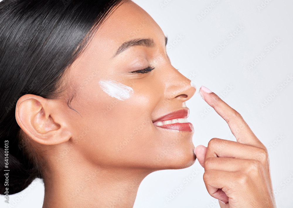 Face, cream and woman with skincare, beauty and self care on a white studio background. Person, prof