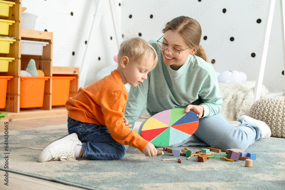 Mother and her little son playing with matching game at home