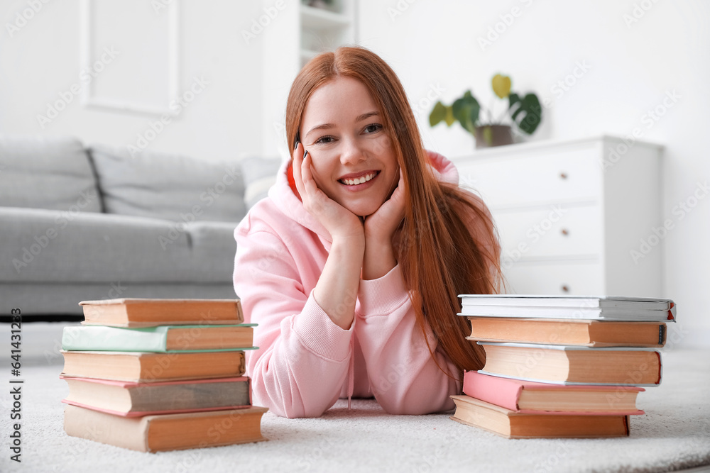 Teenage girl with stacks of books at home