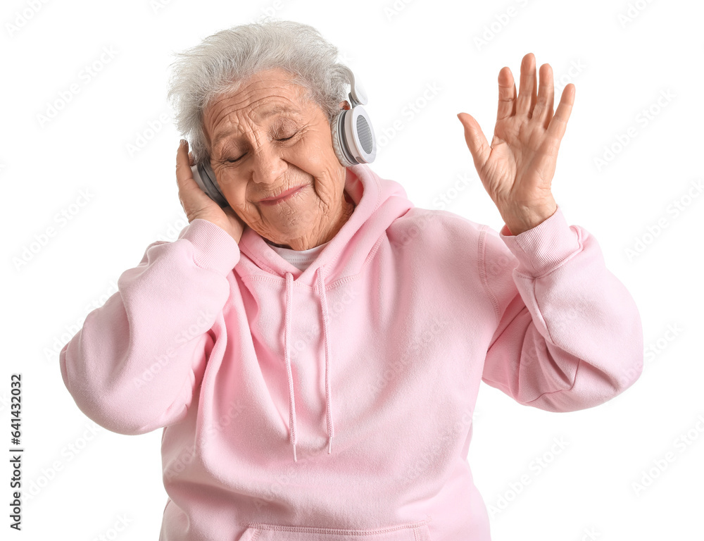 Senior woman in headphones listening to music on white background