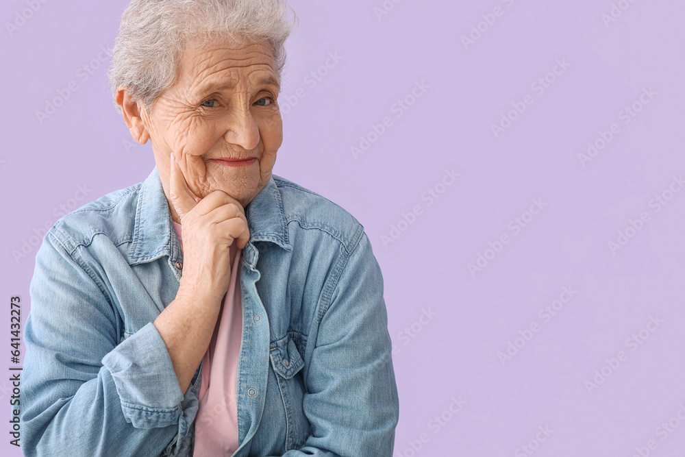 Thoughtful senior woman on lilac background