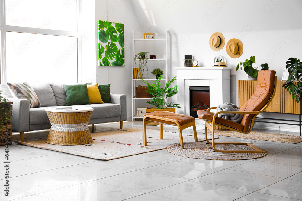 Interior of cozy living room with sofa, armchair and fireplace