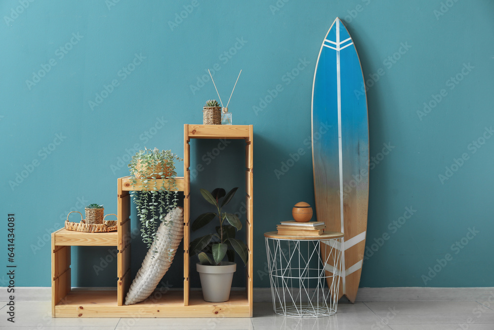 Interior of room with surfboard, table and shelves