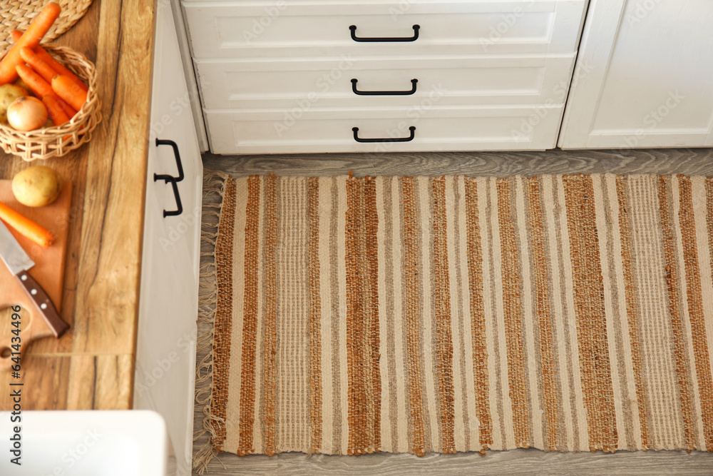 Stylish rug on floor in modern kitchen