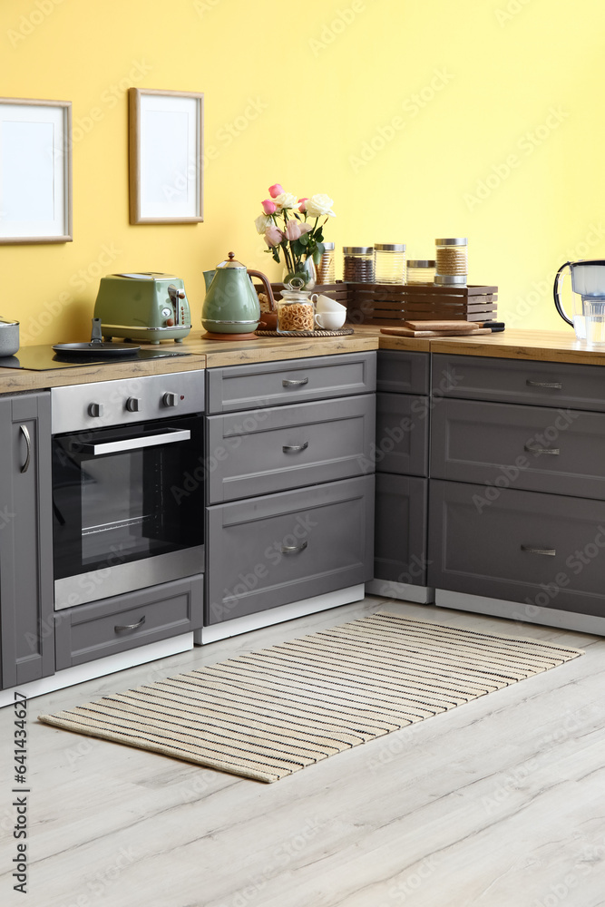 Interior of modern kitchen with stylish rug