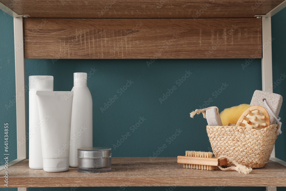 Shelving unit with bath accessories near blue wall, closeup