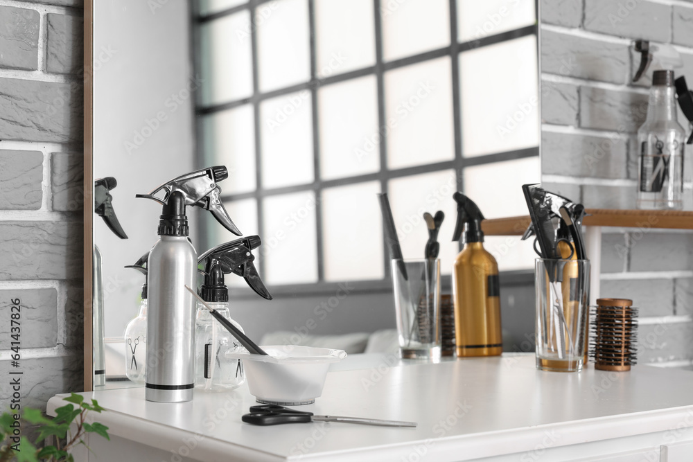 Different hairdressing tools on table in beauty salon