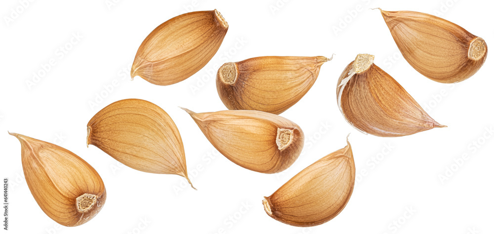 Falling garlic cloves isolated on white background