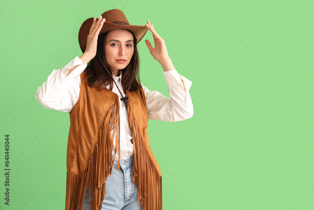 Beautiful cowgirl on green background