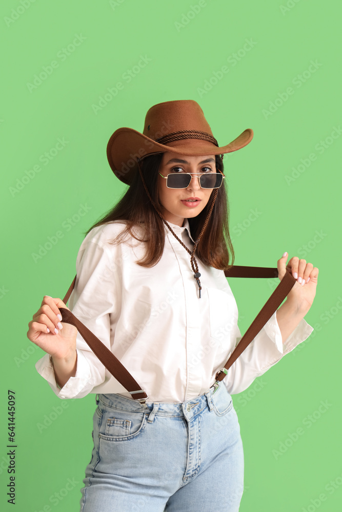 Beautiful cowgirl on green background