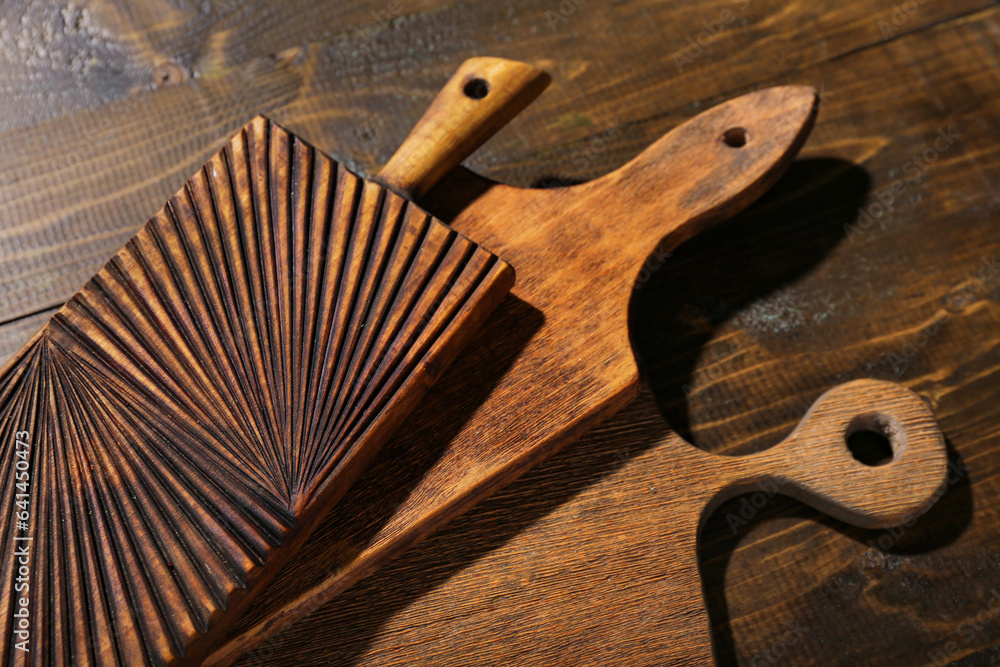 Different cutting boards on wooden background