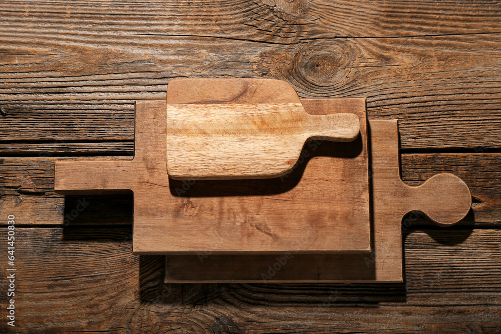 Different cutting boards on wooden background