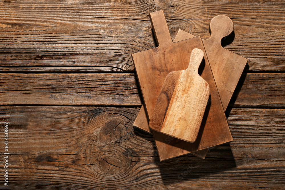 Different cutting boards on wooden background