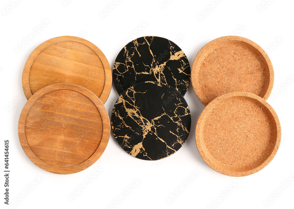 Set of table coasters and plates on white background