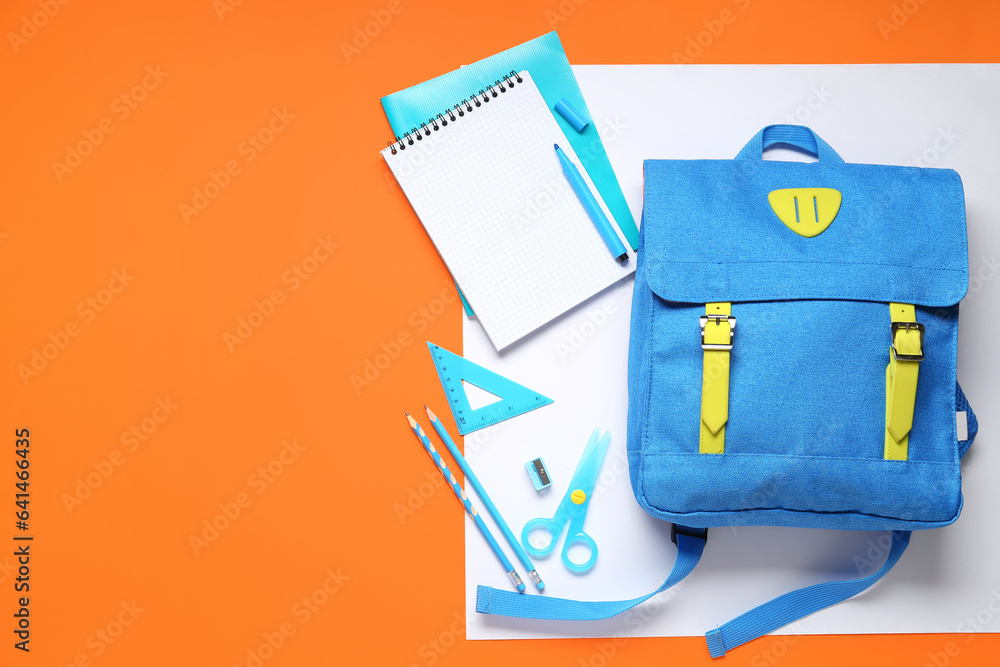 Stylish school backpack with different stationery on color background