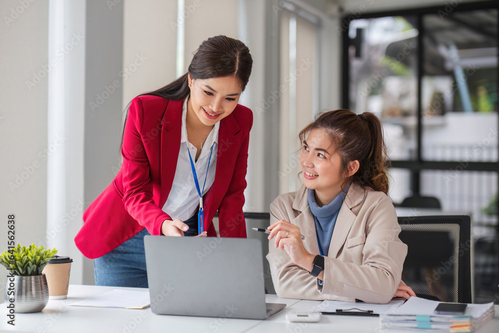 Two business women are discussing and exchanging knowledge on graphs and finance data.